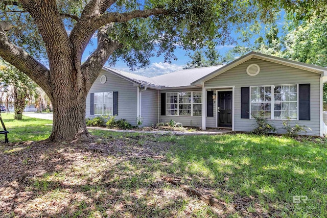 221 Howard Cir, Gulf Shores, AL 36542 - single story home with a front yard and a metal roof