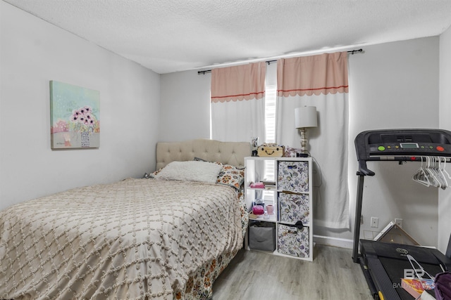 221 Howard Cir, Gulf Shores, AL 36542 - bedroom featuring wood finished floors and a textured ceiling