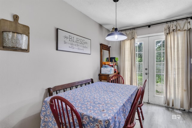 221 Howard Cir, Gulf Shores, AL 36542 - dining room featuring wood finished floors, french doors, and a textured ceiling