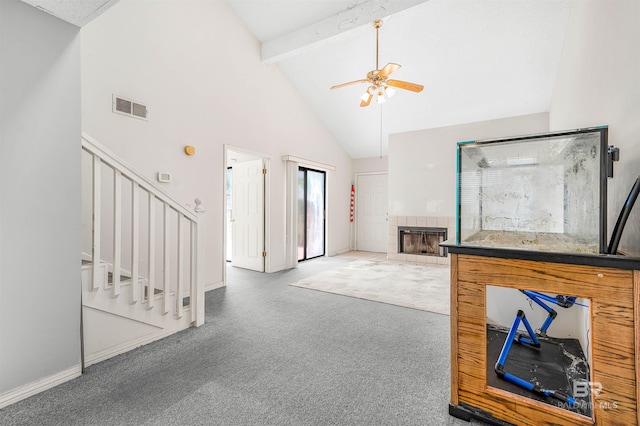 carpeted living room with beamed ceiling, ceiling fan, high vaulted ceiling, and a fireplace