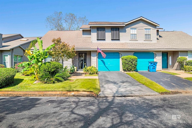 front of property featuring a front lawn and a garage