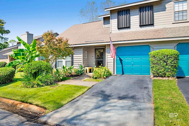 view of front facade featuring a front yard and a garage