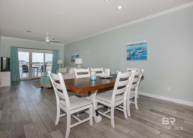 dining space featuring ceiling fan, a textured ceiling, hardwood / wood-style flooring, and ornamental molding