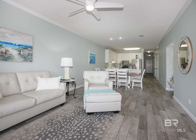 living room featuring a textured ceiling, crown molding, hardwood / wood-style floors, and ceiling fan