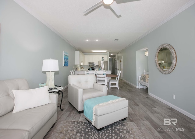 living room featuring light hardwood / wood-style flooring, crown molding, and ceiling fan