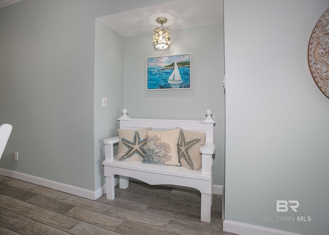 bathroom with a notable chandelier and wood-type flooring