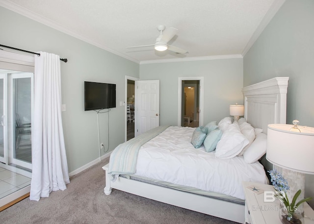 carpeted bedroom featuring ceiling fan and crown molding