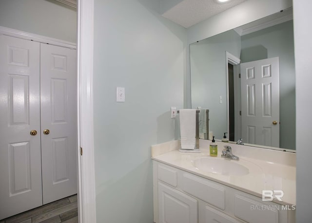 bathroom featuring vanity, a textured ceiling, and wood-type flooring