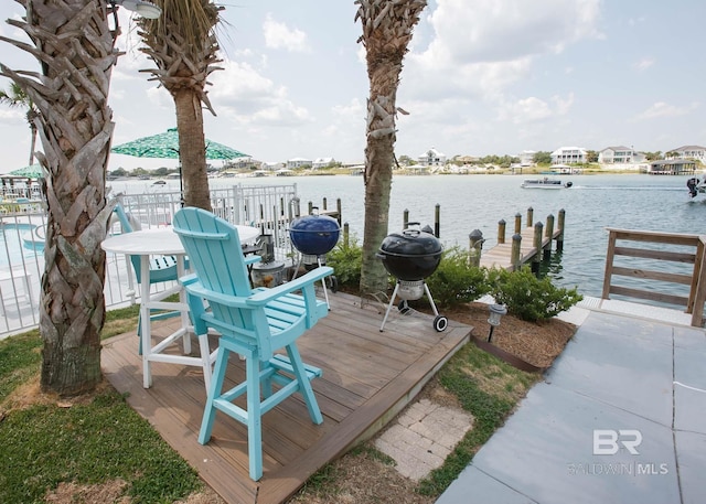 wooden terrace with a dock, a water view, and area for grilling