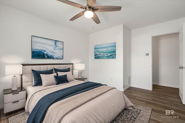 bedroom with wood finished floors, baseboards, and ceiling fan
