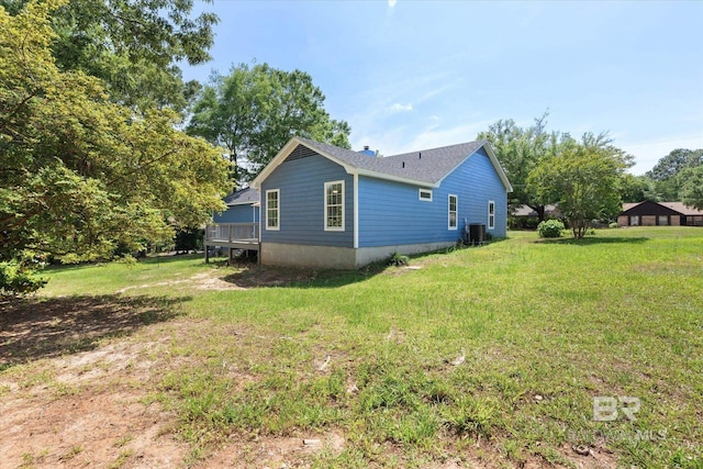 view of property exterior with a yard and central AC