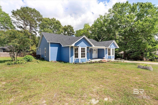 single story home with covered porch, central AC, fence, a front lawn, and roof with shingles