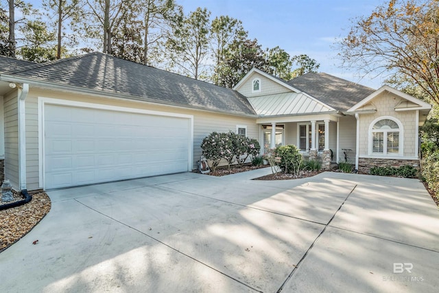 ranch-style house with concrete driveway, stone siding, covered porch, a garage, and a shingled roof