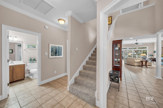staircase featuring ornate columns, tile patterned floors, ceiling fan, and visible vents