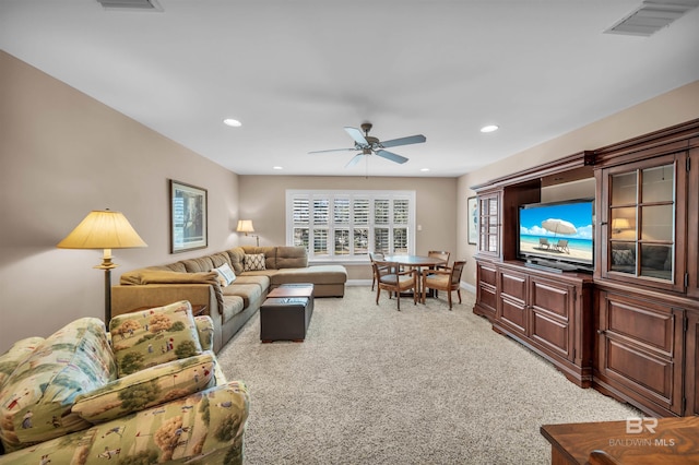 living room with visible vents, baseboards, ceiling fan, recessed lighting, and light colored carpet