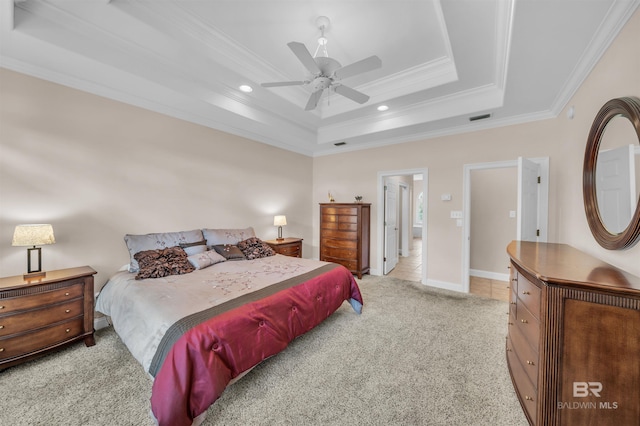 carpeted bedroom with visible vents, crown molding, ceiling fan, a raised ceiling, and tile patterned flooring