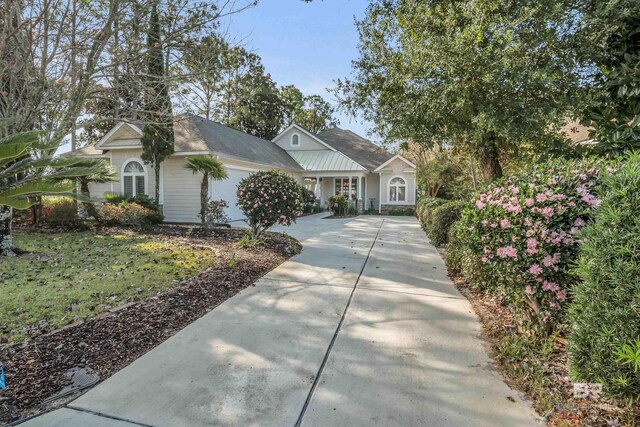 view of front of house featuring concrete driveway and an attached garage
