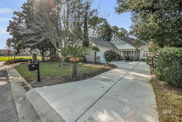 ranch-style home with driveway, a front yard, and a garage