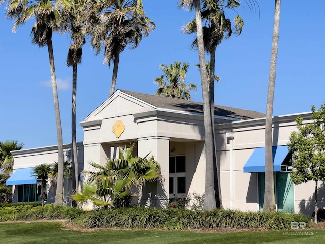 view of side of property with stucco siding