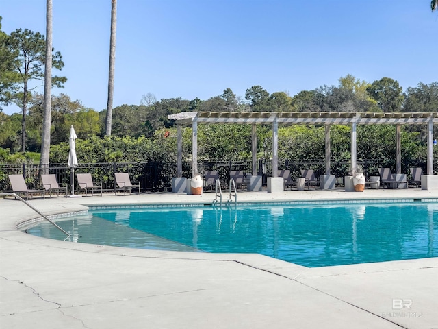community pool featuring a pergola, fence, and a patio