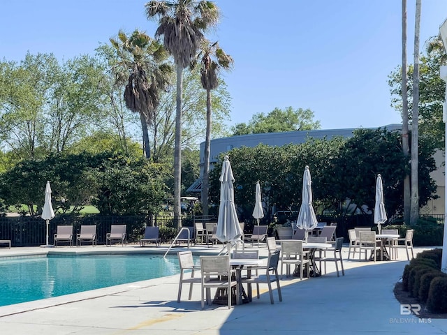 pool featuring a patio area and fence