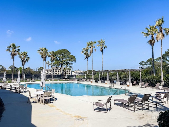 pool with a patio, fence, and a pergola