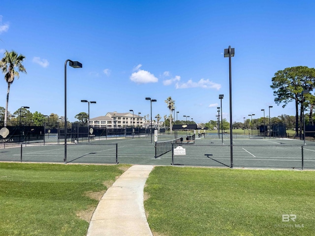 view of sport court featuring a lawn and fence