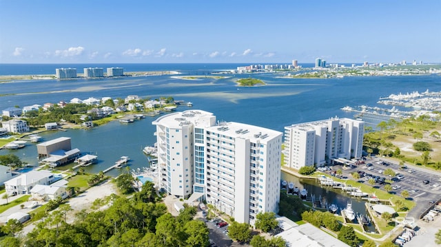 birds eye view of property with a city view and a water view