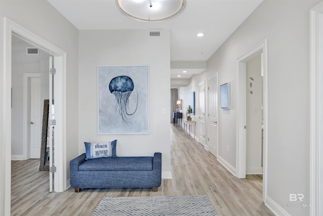 hall with recessed lighting, visible vents, light wood-style flooring, and baseboards