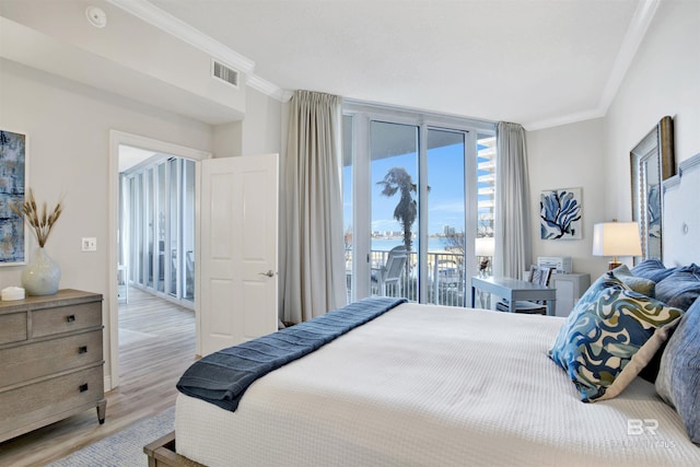 bedroom with visible vents, light wood finished floors, ornamental molding, floor to ceiling windows, and access to outside