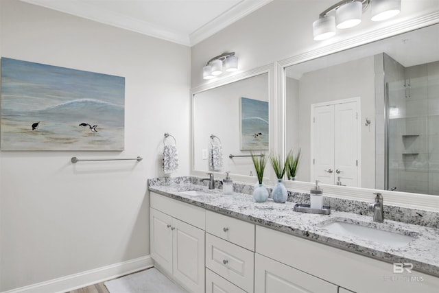 full bathroom with crown molding, a shower stall, and a sink