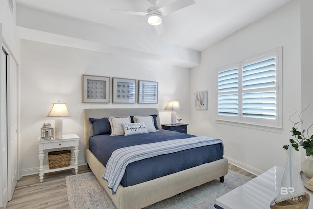 bedroom featuring baseboards, ceiling fan, and light wood finished floors