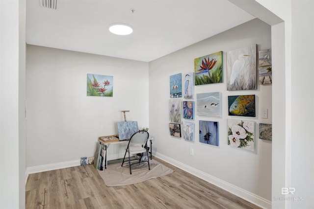 home office with visible vents, baseboards, and wood finished floors