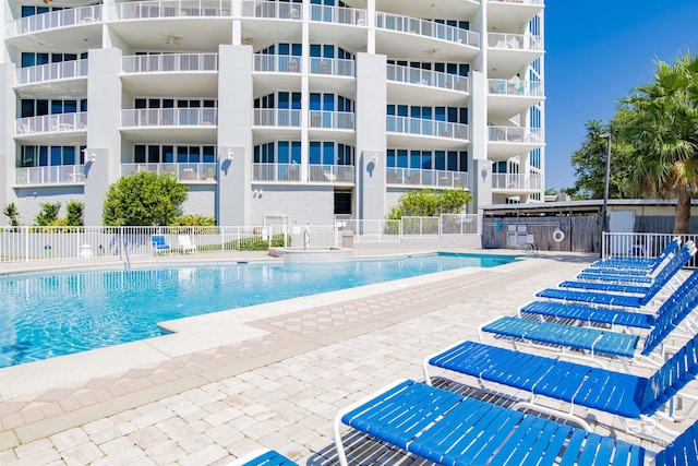 pool featuring a patio area and fence