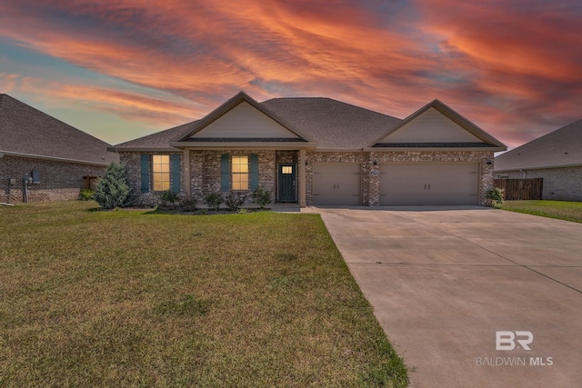 view of front of home with an attached garage, brick siding, a lawn, and concrete driveway