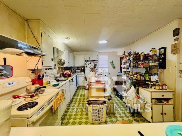 kitchen featuring white appliances and white cabinets