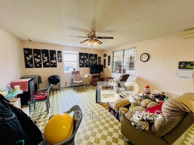 living room with carpet flooring and ceiling fan