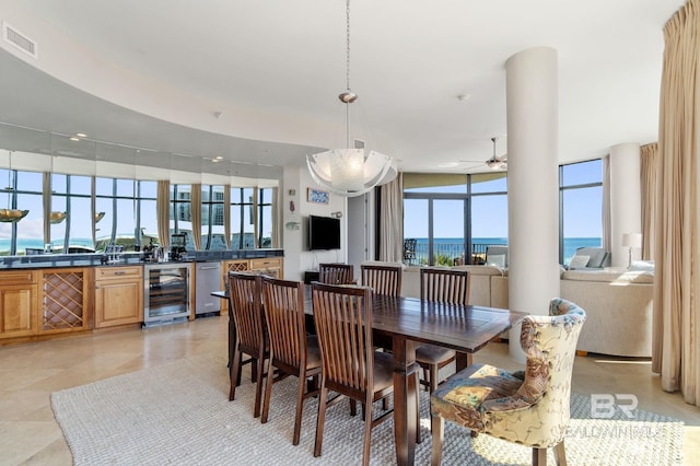 dining room with wine cooler, visible vents, and ceiling fan