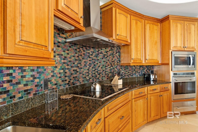 kitchen with a warming drawer, decorative backsplash, appliances with stainless steel finishes, dark stone counters, and wall chimney exhaust hood