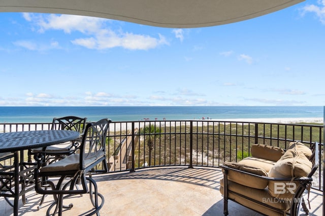 balcony featuring a beach view and a water view