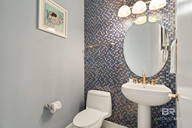 half bath with decorative backsplash, tile walls, and toilet