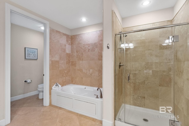 bathroom with a garden tub, a shower stall, toilet, and baseboards