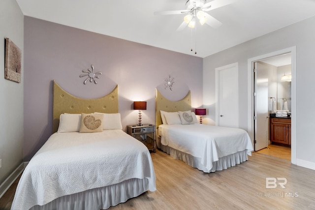 bedroom with a ceiling fan, light wood-type flooring, baseboards, and ensuite bathroom