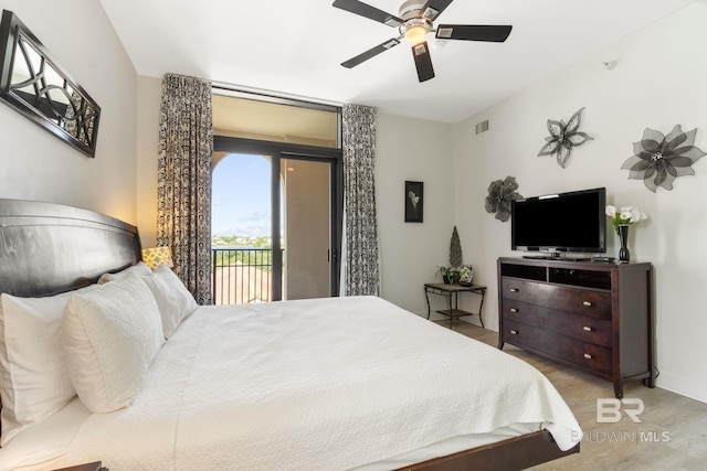 bedroom featuring a ceiling fan, wood finished floors, visible vents, and access to exterior