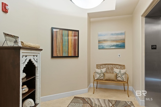 sitting room with tile patterned floors and baseboards