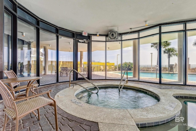 view of pool with a community hot tub