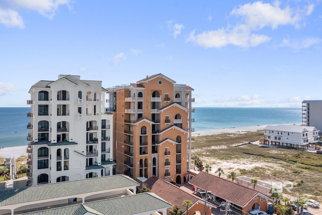 view of property featuring a water view and a beach view