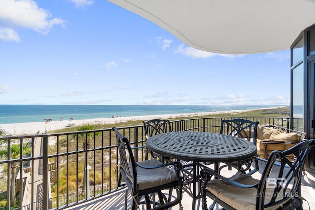 balcony featuring a water view and a view of the beach