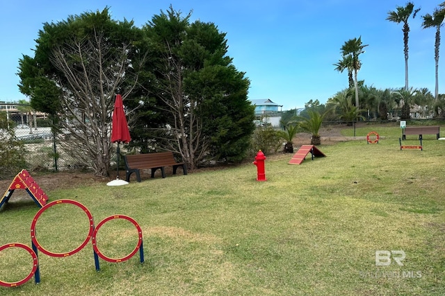 exterior space featuring a lawn and fence