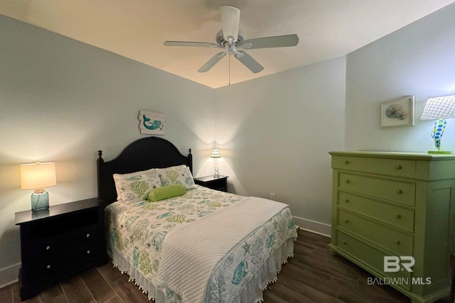 bedroom featuring dark wood finished floors, a ceiling fan, and baseboards